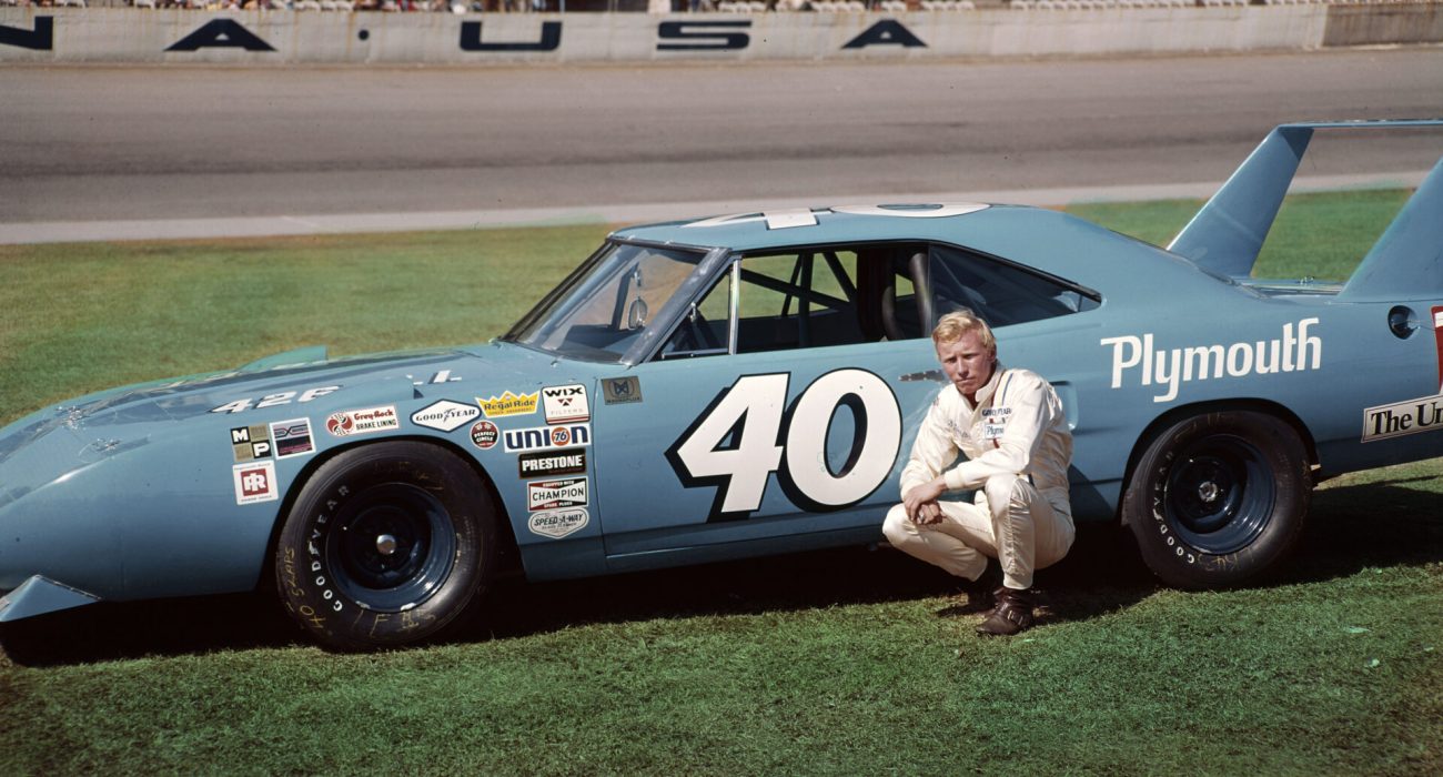 Pete Hamilton – NASCAR Daytona 1970 DAYTONA BEACH, FL — 1970: Pete Hamilton with the Petty Enterprises 7-Up Plymouth Superbird he ran at Daytona International Speedway. After scoring a huge victory in the February Daytona 500, Hamilton suffered ignition problems in the July Firecracker 400 and was scored in 30th position. (Photo by ISC Images & Archives via Getty Images)